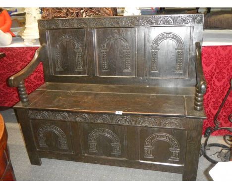 A Victorian carved oak monk's bench.