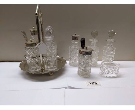 A four bottle cruet set, 4 cruet bottles and a napkin ring.