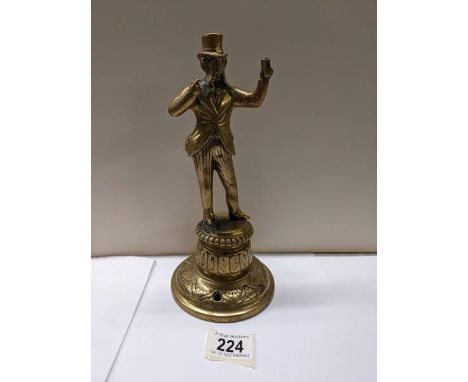 A Victorian brass figure bar top mains gas lighter, 24 cm tall.