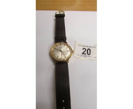A Rotary manual wind with gold coloured case, champagne dial, brown leather strap, in working order.