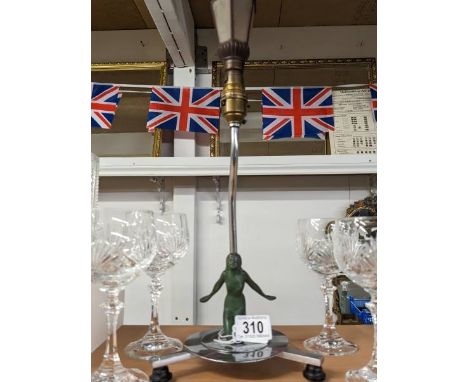 An original chrome art deco table lamp with verdigree spelter kneeling nude with rare street lantern light bulb.