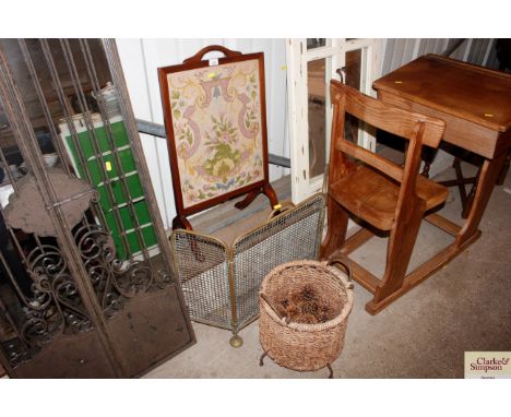 A needlework fire screen; a brass spark guard and a twin handled log basket 
