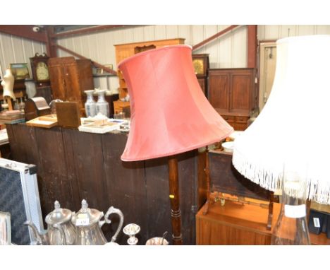 An oak turned standard lamp with red shade 