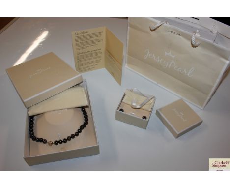 A boxed Jersey pearl necklace; and  matching Jersey pearl ear-rings with original box 