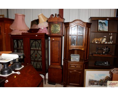 An oak and mahogany cross banded longcase clock by Jno. Howe Watchett, the brass dial with engraved decoration surrounded by 