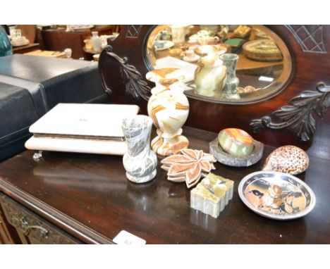 An onyx box raised on paw feet; and an onyx type candlestick and egg etc.