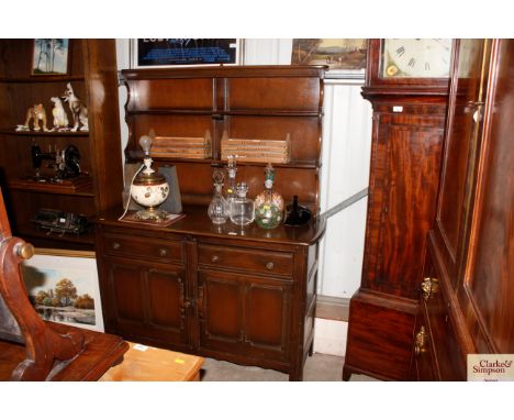 An Ercol dresser raised on cupboard base and fitted two drawers 