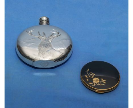 A hip flask and a powder compact