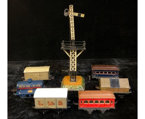 A collection of Hornby O Gauge tinplate rolling stock, comprising a Redline-Glico petrol tank wagon 'REDLINE-GLICO, SUPER PET