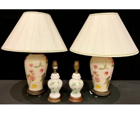 A pair of contemporary Oriental style glass ovoid table lamps, reverse decorated with flowers; a pair of ceramic ovoid table 