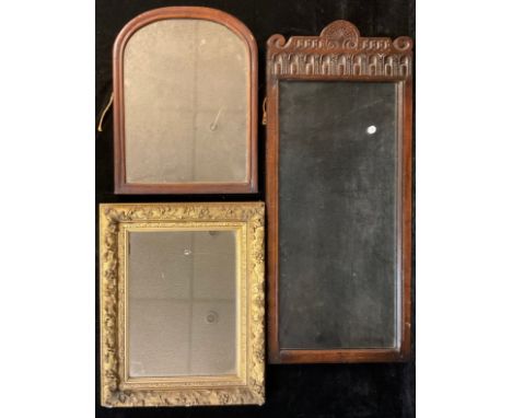 A 19th century gilt gesso rectangular looking glass, 56cm x 46cm; an 18th century carved oak panel, repurposed as a mirror, 9
