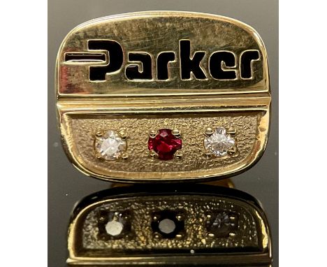 A 9ct gold pin badge, Parker employee award, set with a ruby chip flanked by a pair of diamond chips, 4g 