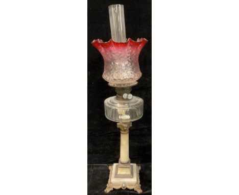 A 19th century oil lamp, brass mounted alabaster column, clear glass reservoir, Duplex twin burner, cranberry flashed fluted 