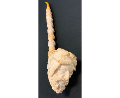 A large meerschaum pipe, carved with the Green Man, leaves and grapes, amber mouth piece, 44cm long, cased 