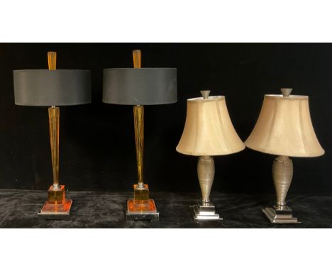 Interior Decoration - a pair of contemporary two light table lamps, each with translucent amber column and pedestal on chrome