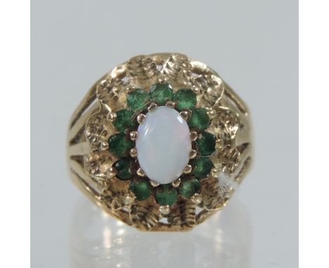 A 9 carat gold opal and emerald cluster ring, boxed 