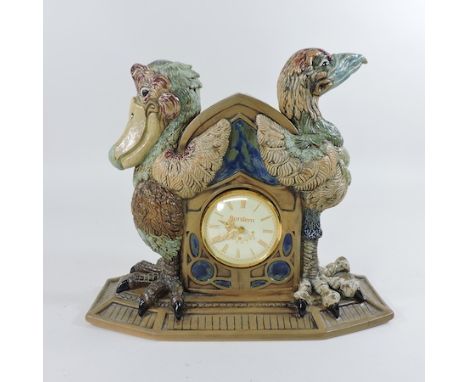 A Cobridge stoneware mantel clock, decorated with grotesque birds, by Andrew Hull, 26cm tall
