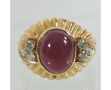 An 18 carat gold, cabochon ruby and diamond ring, approximately 2 carat