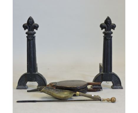 A pair of 19th century iron fire dogs, each 58cm tall, and a pair of bellows and fire tools