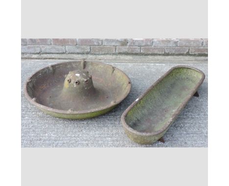 A cast iron circular pig trough, 71cm, together with another