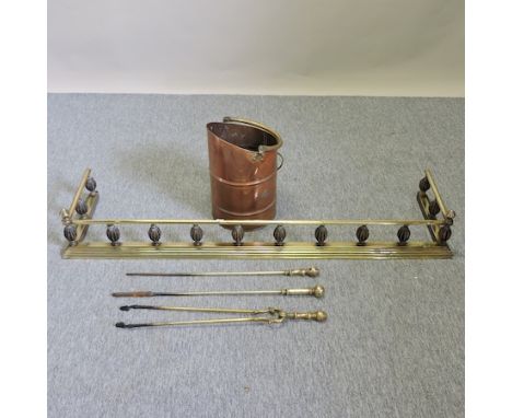 An Edwardian brass fender, 138cm, together with a copper coal scuttle and brass fire tools