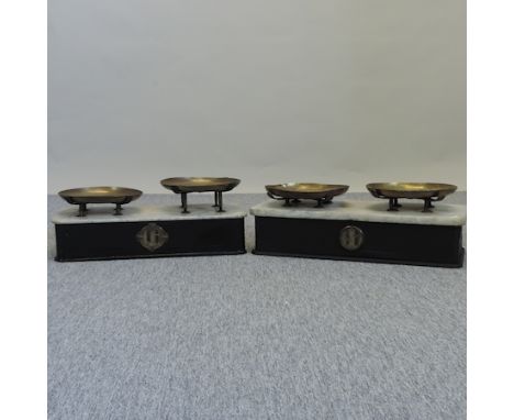 A set of early 20th century French cast iron and marble balance scales, 59cm, together with another bearing a plaque for Usin