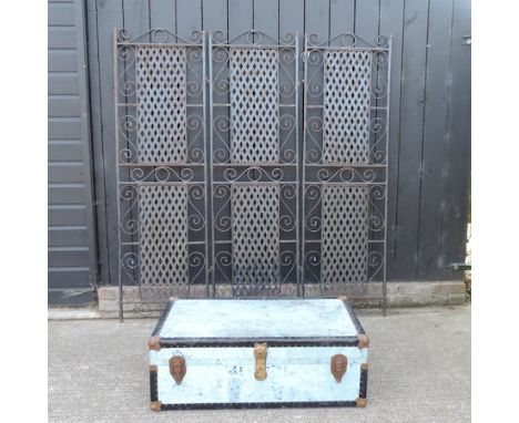 A black painted metal three fold garden screen, 179cm tall, together with a blue travelling trunk