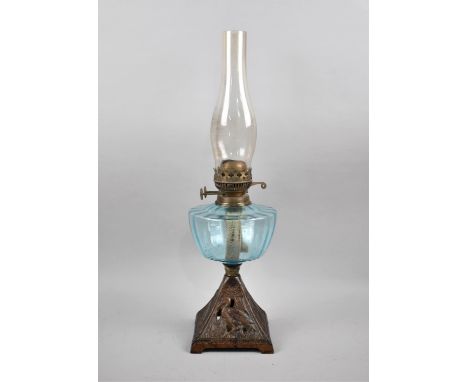 A Late Victorian Iron Base Oil Lamp with Blue Glass Reservoir and Chimney, Dual Controls, 55cm high 