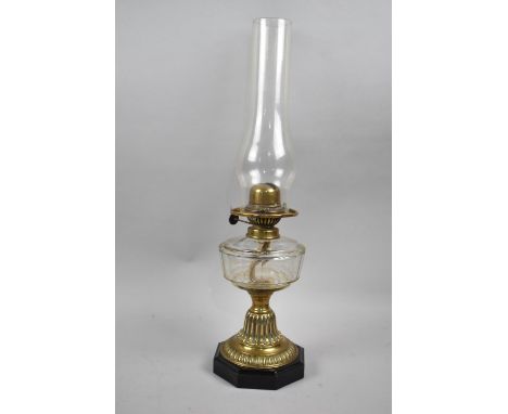 A Late Victorian Brass Based Oil Lamp with Octagonal Plinth Base and Glass Reservoir, Complete with Chimney, 47cm high 
