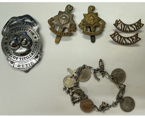 Small collection of mixed collectables to include military cap badges, 925 silver charm bracelet and novelty badge. UK P&amp;