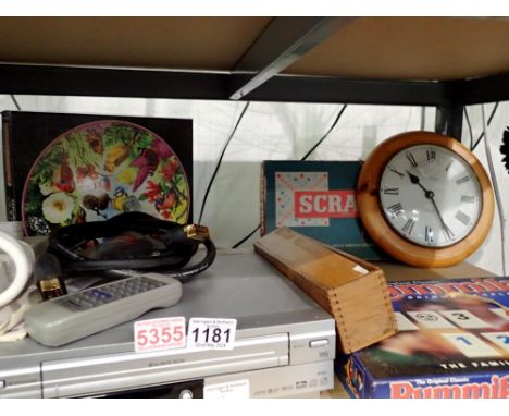 Shelf of mixed games and an LG DVC8700 VHS/DVD recorder/player. All electrical items in this lot have been PAT tested for saf