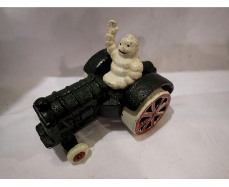 Cast iron Michellin Man on a tractor. H:80mm. UK P&amp;P Group 1 (£16+VAT for the first lot and £2+VAT for subsequent lots) 