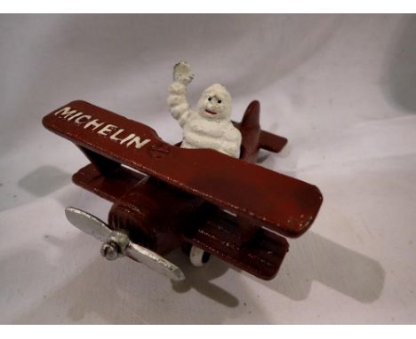 Cast iron Michellin Man in a plane H:80mm. UK P&amp;P Group 1 (£16+VAT for the first lot and £2+VAT for subsequent lots) 