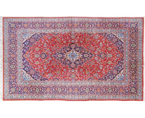 A Kashan Persian carpet - 313X200cm central motif and triple border, main colour red.