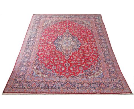A Kashan Persian carpet - 425X313cm central motif, triple border, main colour red.