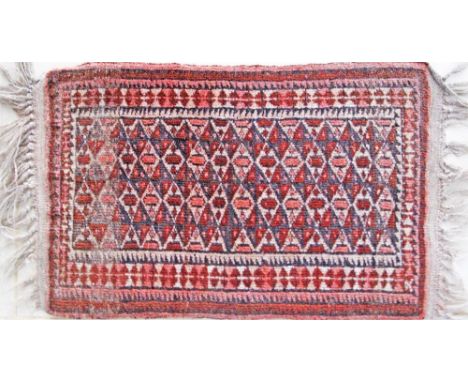 A small Anatolian carpet / mat with geometric motifs. 70X40cm.