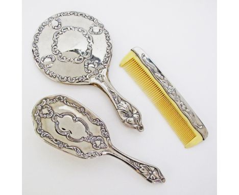 An unmarked silver mounted brush, comb and mirror L24cm in the Art Nouveau style.(3)