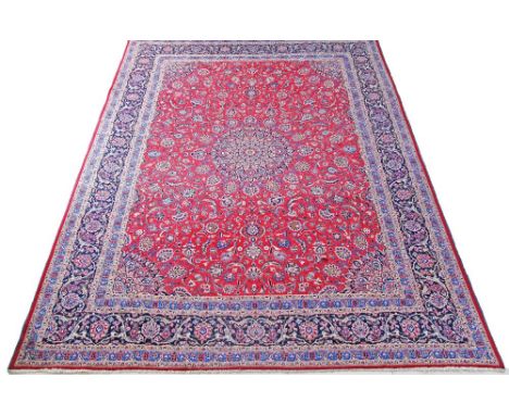 A Kashmar Persian carpet - 390X298cm central motif, triple border, main colour red.