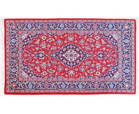 A Kashan Persian carpet - 217X124cm central motif and triple border, main colour red.
