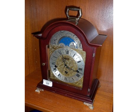 A Hermle bracket clock with brass face with silvered chapter ring and moonphase chiming on a gong