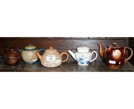 Two Chinese decorated red ware teapots, a blue and white small teapot, an English treacle glazed teapot (A/F) and a tea bowl 