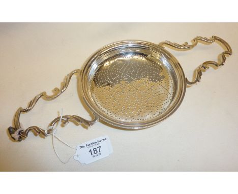 Large fine Georgian silver double scroll handled lemon squeezer. Diameter c. 13cm, length 29cm and weight 196g