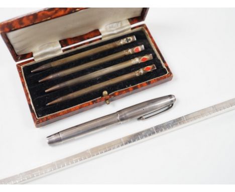 An engine-turned silver fountain pen, a cased set of four silver Bridge pencils and a silver combination pencil/rule