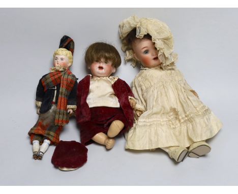 A German bent limb doll, face cracked H12in. German bent limb character baby doll H9in. bisque head Scottish doll with bisque