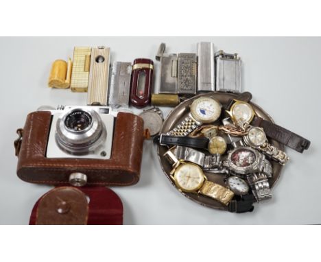 A collection of mixed wristwatches and cigarette lighters and a camera