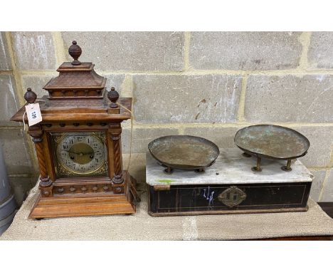 An early 20th century walnut mantel clock, height 53cm together with a set of Victorian scales
