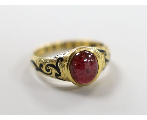 A Victorian 18ct gold, cabochon garnet and black enamel set memorial ring, the shank interior inscribed 'J W Scott obt. 26th 