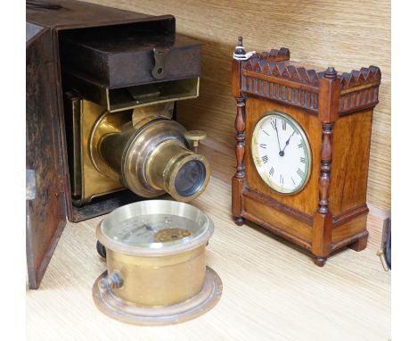 A cased tinplate and pressed brass Magic Lantern, Case 46 cm long, A French walnut cased mantel timepiece, with key, 23cm, an