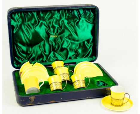 A SET OF FIVE SHELLEY YELLOW COFFEE CUPS AND SIX SAUCERS, WITH PIERCED SILVER CUP HOLDERS AND A REPLACEMENT CUP, IN FITTED CA