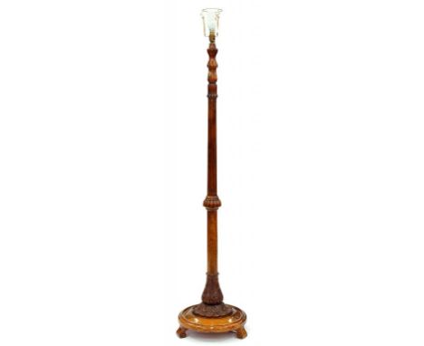 A TURNED AND CARVED WALNUT STANDARD LAMP